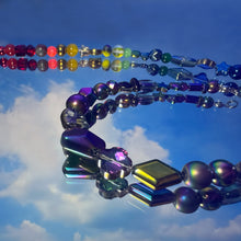 Load image into Gallery viewer, Colorful beaded necklaces with reflective surface against a blue sky.
